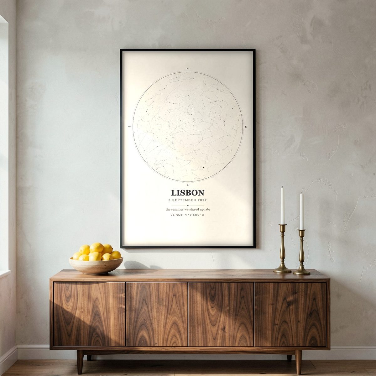 Mockup: a cream Ink-style Skynolie star map in a black frame above a walnut sideboard